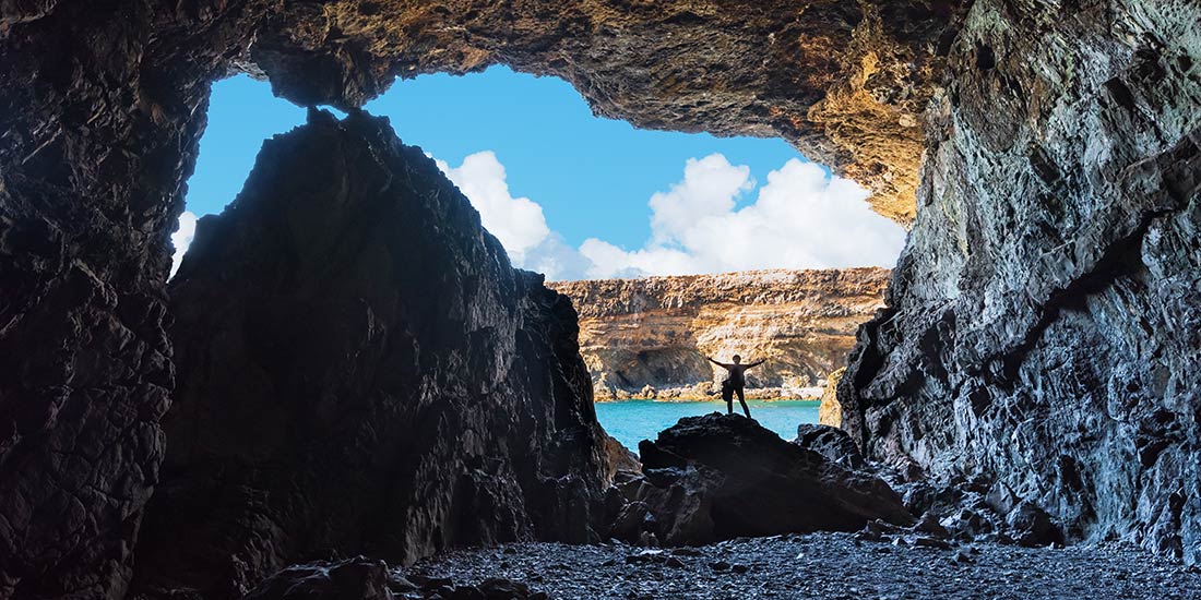Silhouette of woman inside the caves of Ajuy, Fuerteventura, Spain